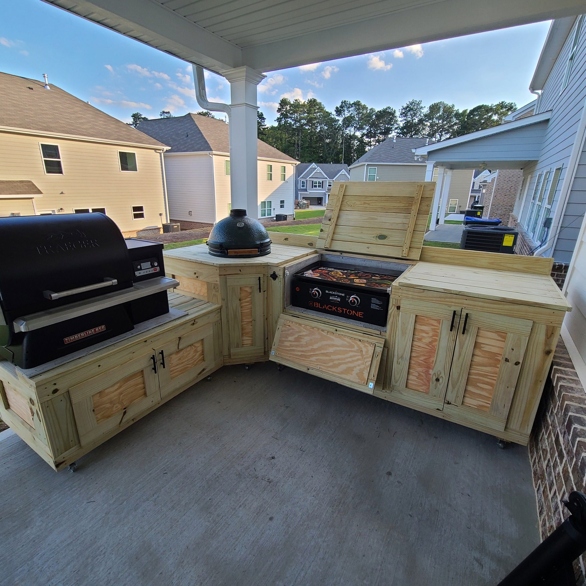 A custom outdoor kitchen with a Big Green Egg in the inside corner. Built by James at Cowboy Country Kitchens. 